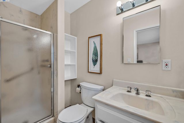 a bathroom with a sink mirror and toilet
