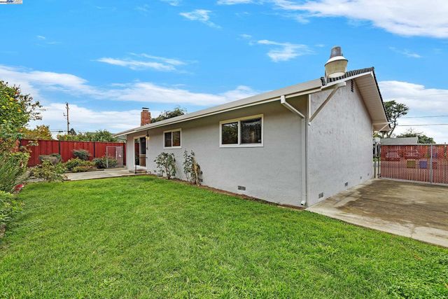 a front view of house with yard and seating area