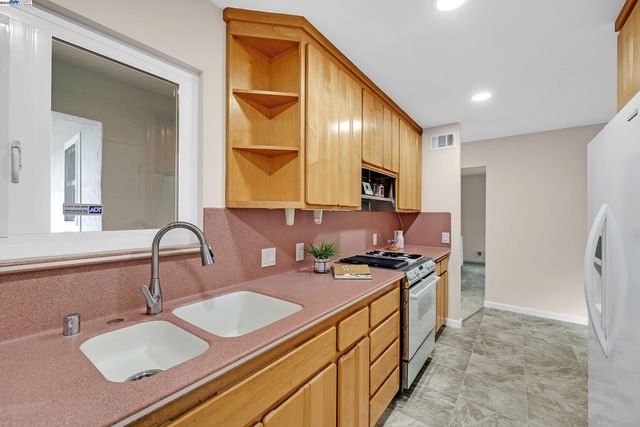 a kitchen with a sink appliances and cabinets