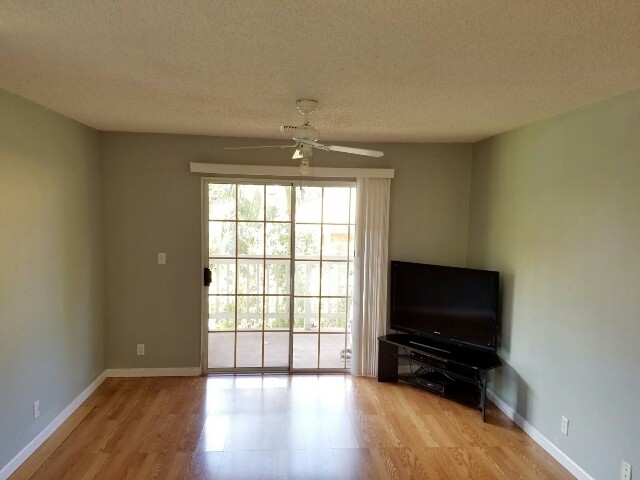 140 Uwapo Road, Unit 22204 Kihei, HI 96753 - Photo 4 of 19 wooden floor in an empty room with a window