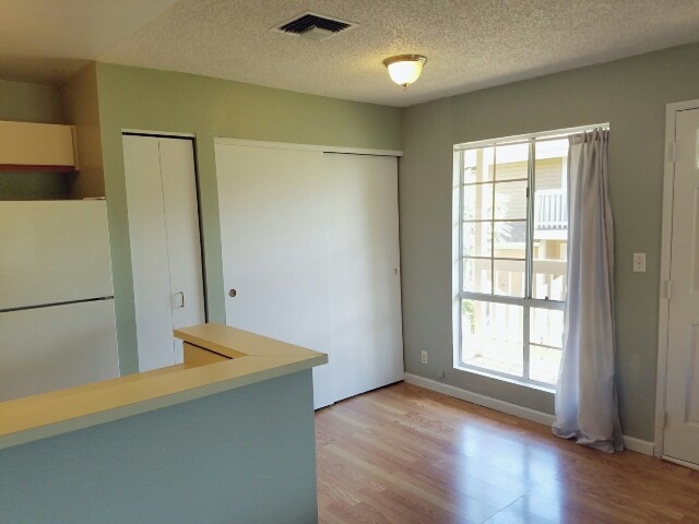 140 Uwapo Road, Unit 22204 Kihei, HI 96753 - Photo 6 of 19 a view of an empty room with wooden floor and a window
