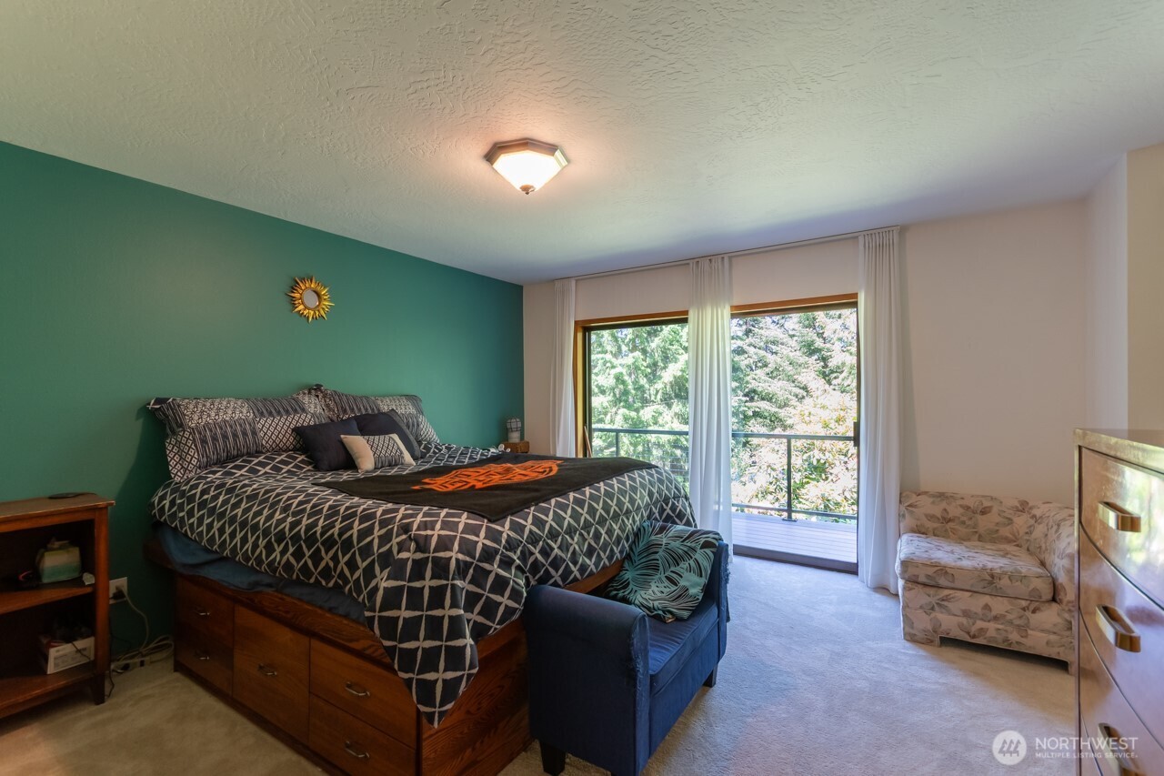 492 Walkabout Way Port Angeles, WA 98363 - Photo 21 of 40 a bedroom with a bed and a window