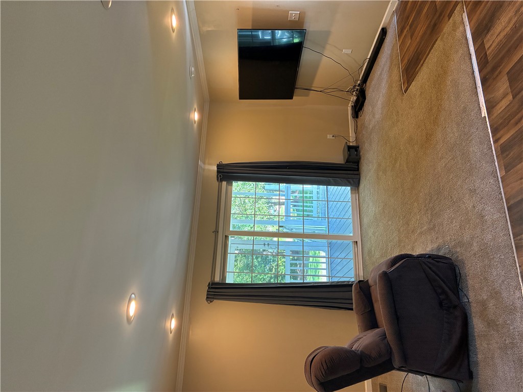 125 Ricks Road Fair Play, SC 29643 - Photo 6 of 26 Recessed lighting illuminates this inviting space featuring plush carpeting and a large sliding glass door.
