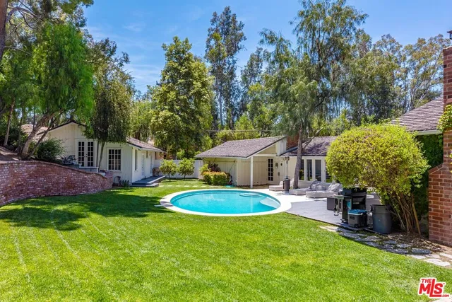 a view of a house with swimming pool and sitting area