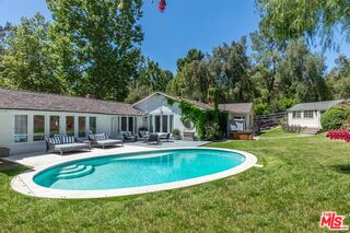5840 Round Meadow Road Hidden Hills, CA 91302 - Photo 2 of 28 a view of a house with swimming pool and sitting area