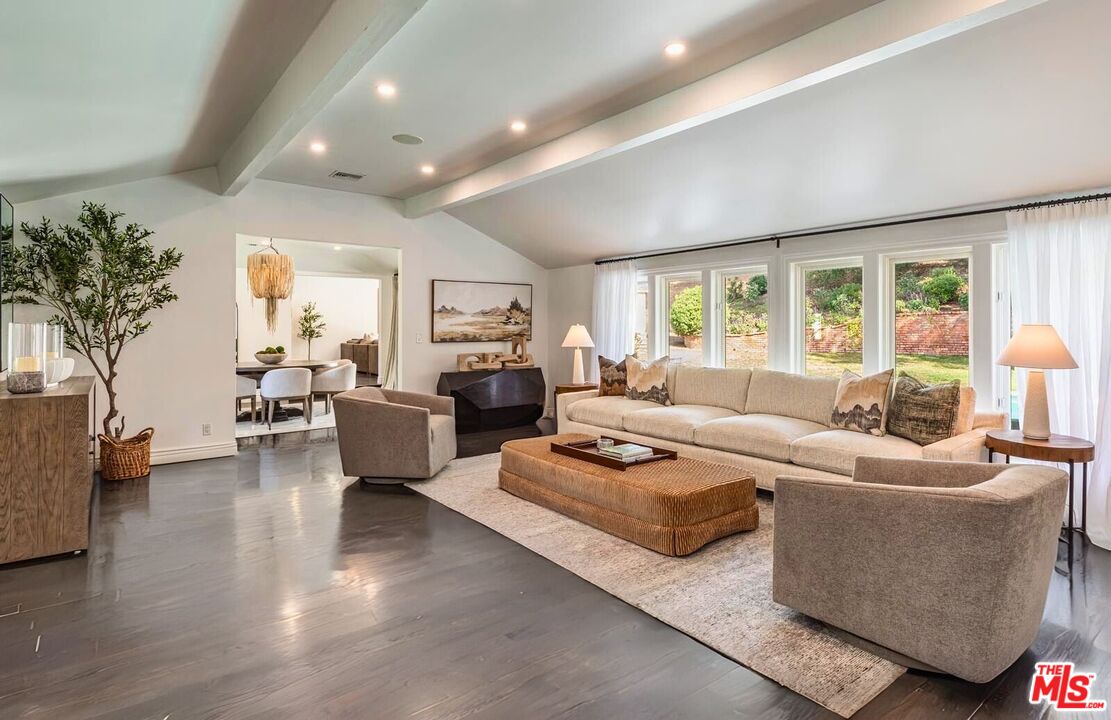 5840 Round Meadow Road Hidden Hills, CA 91302 - Photo 5 of 28 a living room with furniture fireplace and a large window