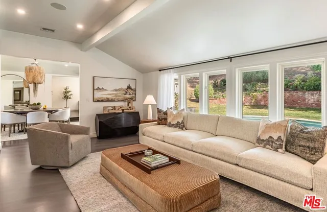 a view of a house with swimming pool and sitting area