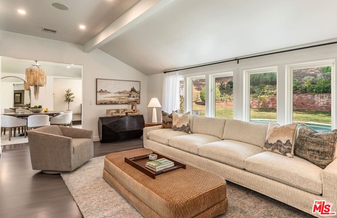 5840 Round Meadow Road Hidden Hills, CA 91302 - Photo 6 of 28 a living room with furniture large window and a fireplace