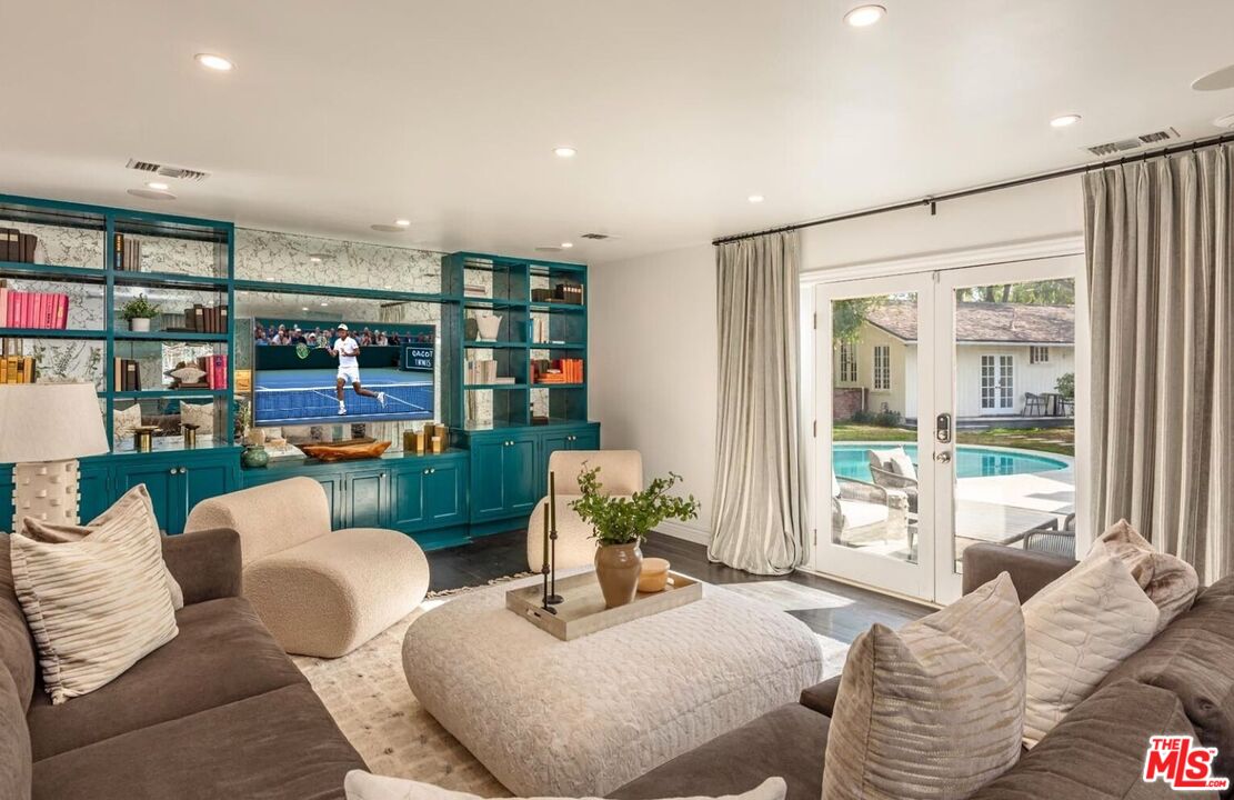 5840 Round Meadow Road Hidden Hills, CA 91302 - Photo 8 of 28 a living room with furniture and a floor to ceiling window