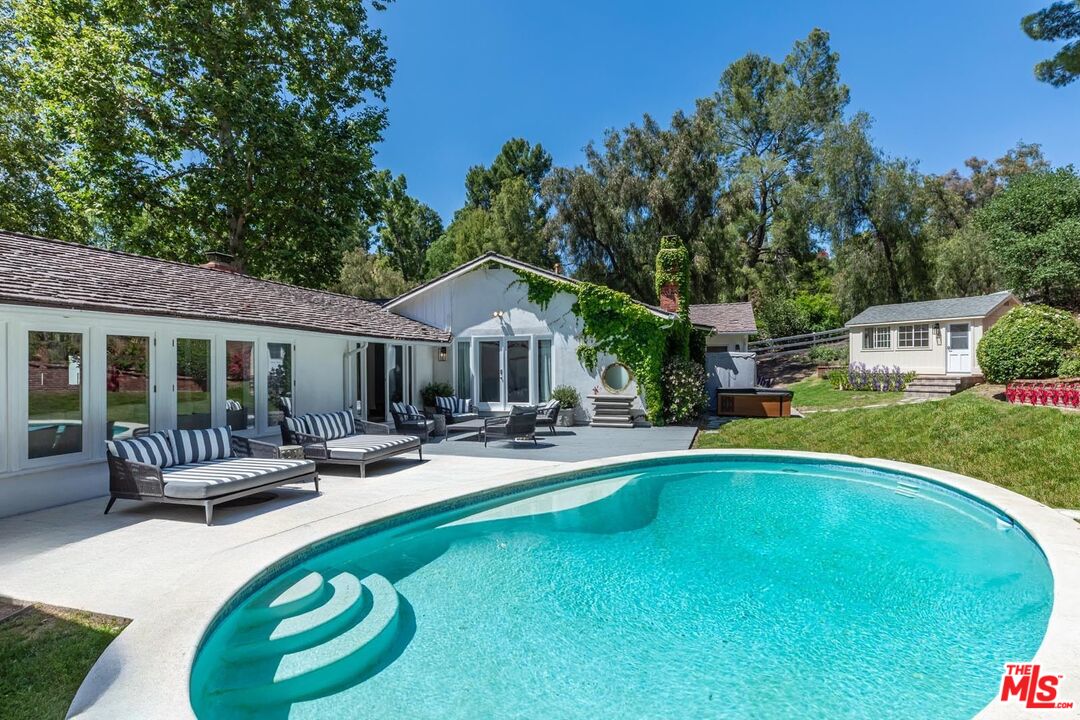 5840 Round Meadow Road Hidden Hills, CA 91302 - Photo 9 of 28 a view of a house with swimming pool and sitting area