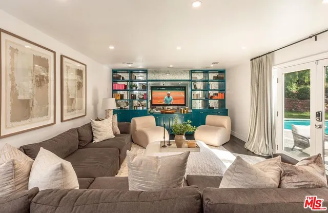 a front view of a house with a yard and potted plants