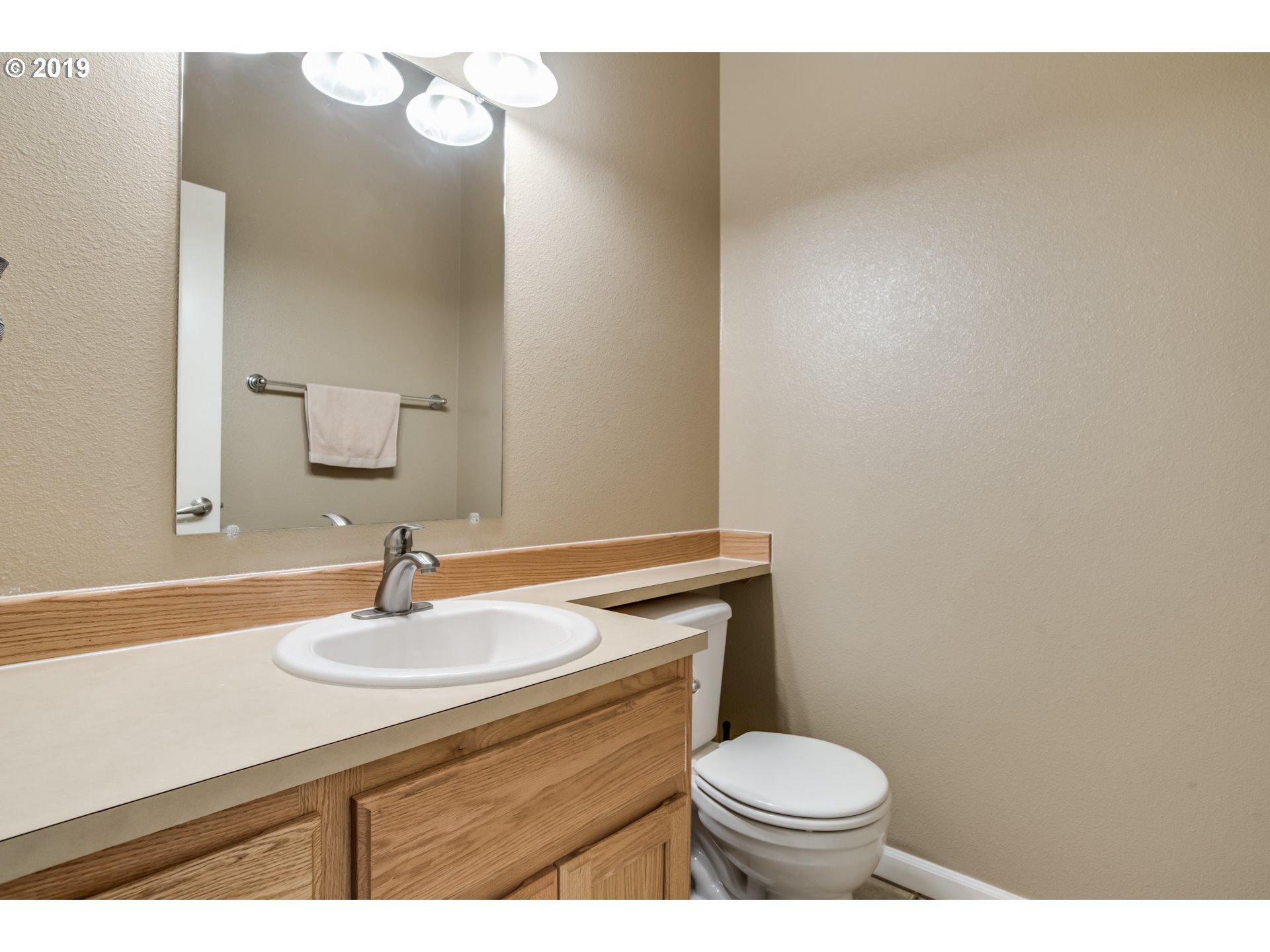 2014 North Falcon Drive Ridgefield, WA 98642 - Photo 17 of 32 a bathroom with a sink a toilet and a mirror