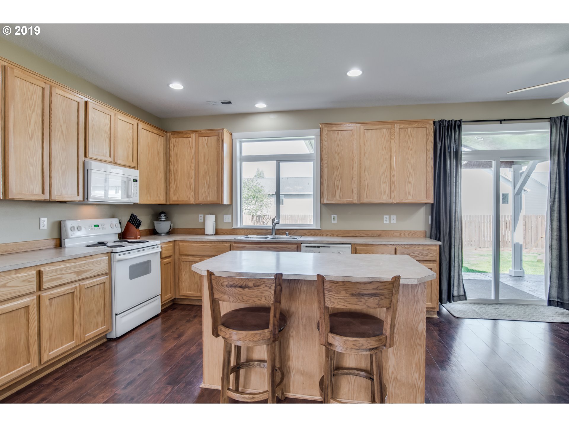 2014 North Falcon Drive Ridgefield, WA 98642 - Photo 21 of 32 a open kitchen with a sink cabinets and wooden floor