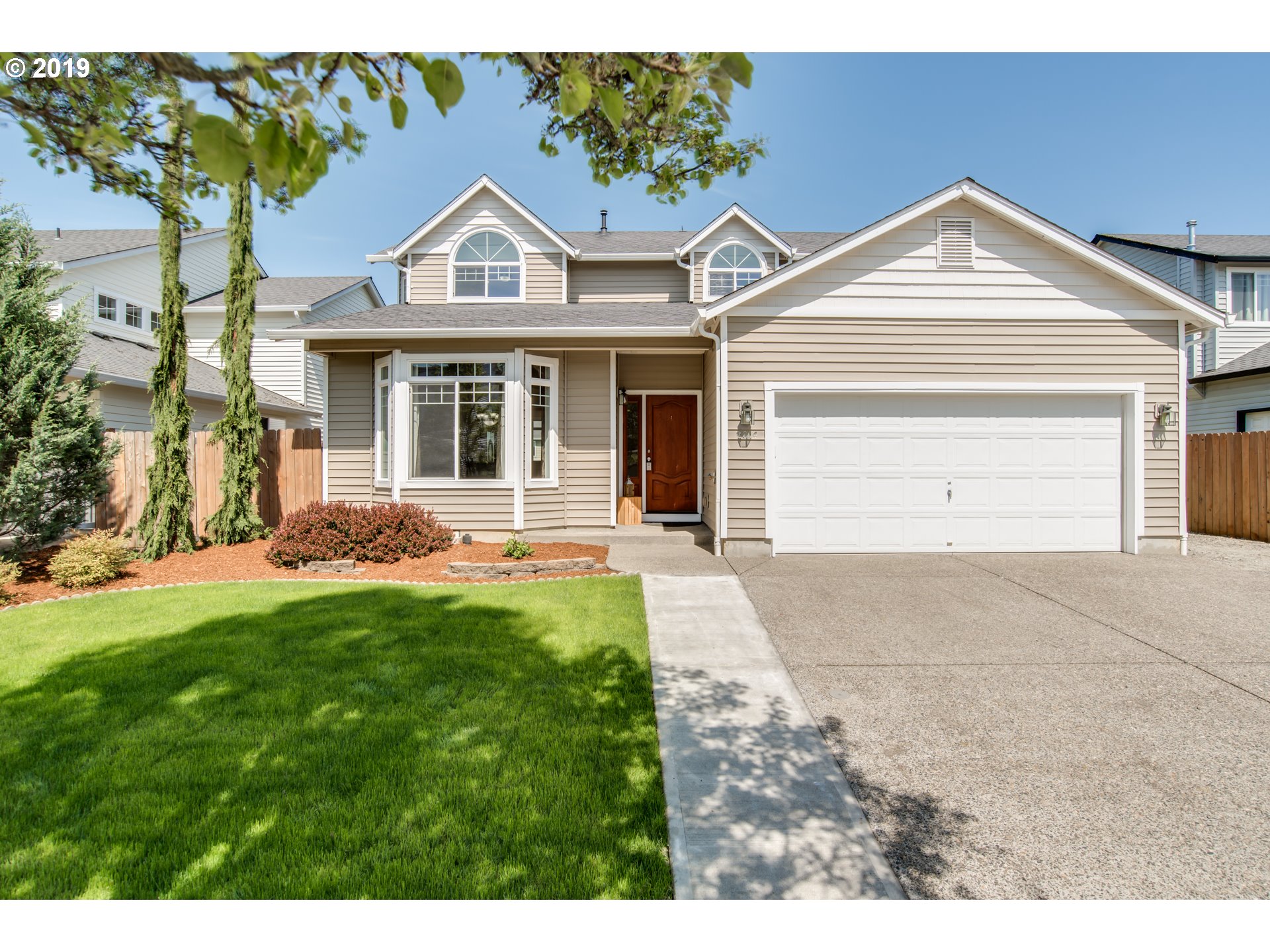 2014 North Falcon Drive Ridgefield, WA 98642 - Photo 27 of 32 a front view of a house with a yard and garage