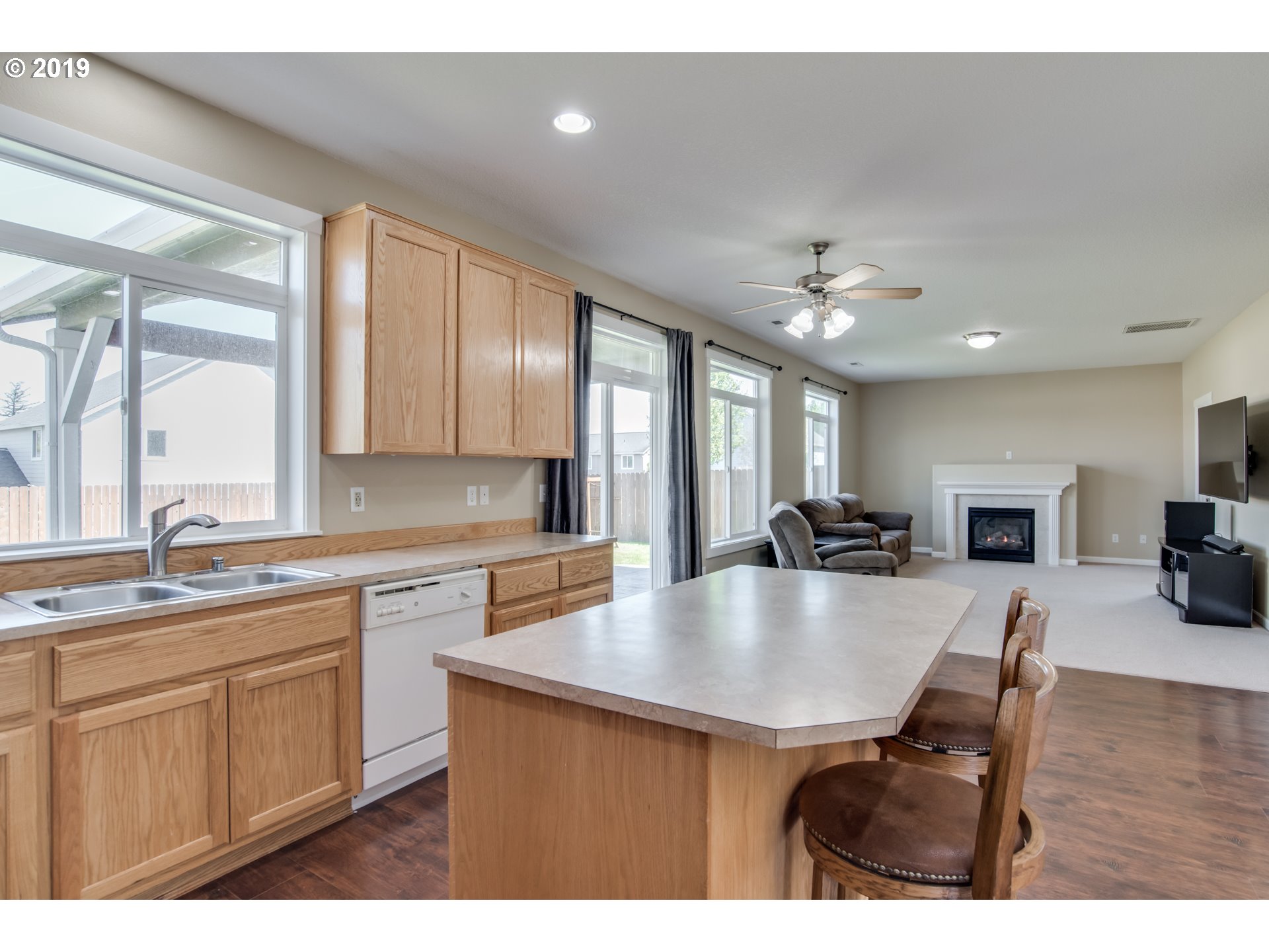 2014 North Falcon Drive Ridgefield, WA 98642 - Photo 5 of 32 a large kitchen with kitchen island a stove a sink a refrigerator dining table and chairs