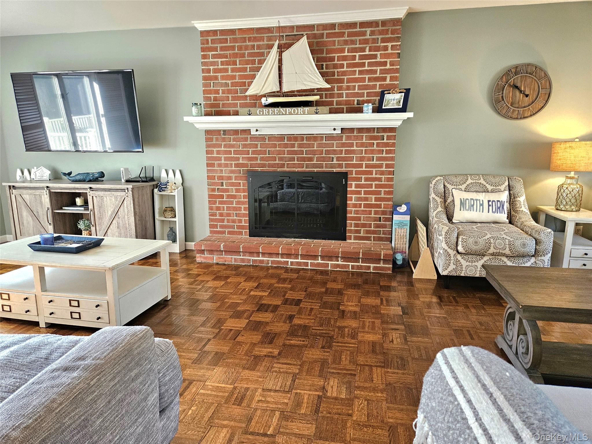 3650 Bay Shore Road Greenport, NY 11944 - Photo 16 of 30 a living room with a couch and a fireplace