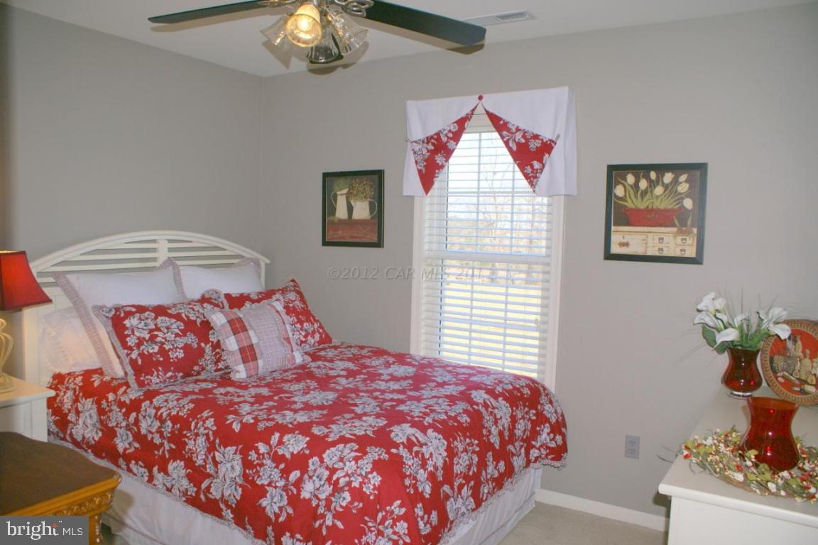 3535 Redden Ferry Road Eden, MD 21822 - Photo 15 of 24 a bedroom with a bed and a chandelier