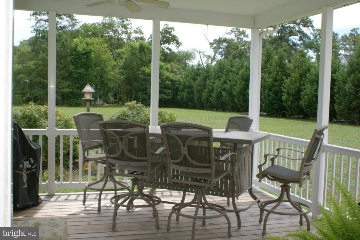 3535 Redden Ferry Road Eden, MD 21822 - Photo 21 of 24 a view of a patio with a table chairs and a floor to ceiling window