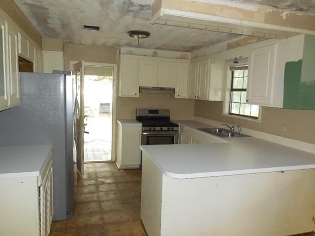 1104 Foreman Road Doyline, LA 71023 - Photo 5 of 11 a kitchen with a sink and a refrigerator