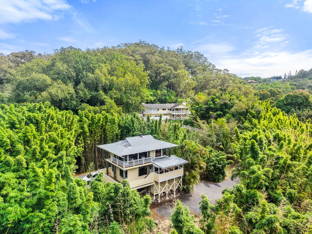 a aerial view of a house with yard and outdoor seating