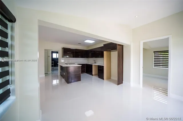 a kitchen with a refrigerator and a kitchen counter top space