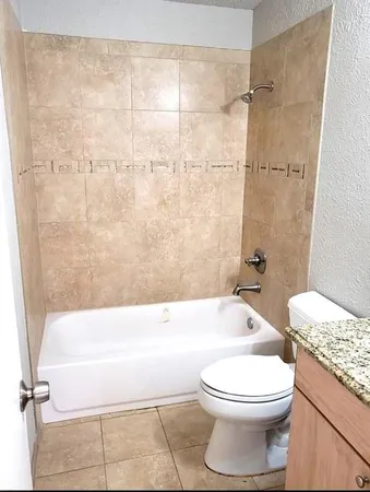 a bathroom with a toilet a sink and bathtub