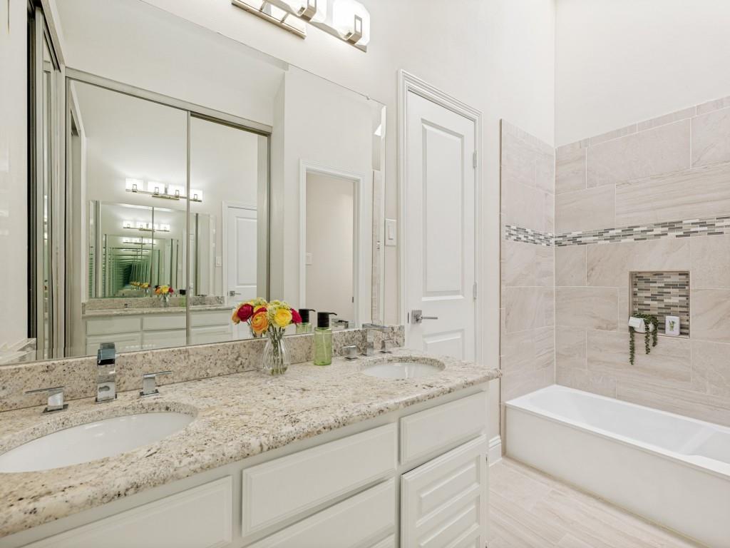 4010 Rive Lane Addison, TX 75001 - Photo 20 of 25 a bathroom with a tub sink and mirror
