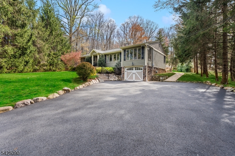 a view of a house with a yard and sitting area