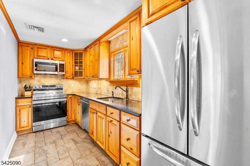 21 Turkey Hill Road Montville, NJ 07005 - Photo 11 of 32 a kitchen with stainless steel appliances granite countertop a refrigerator and a stove top oven