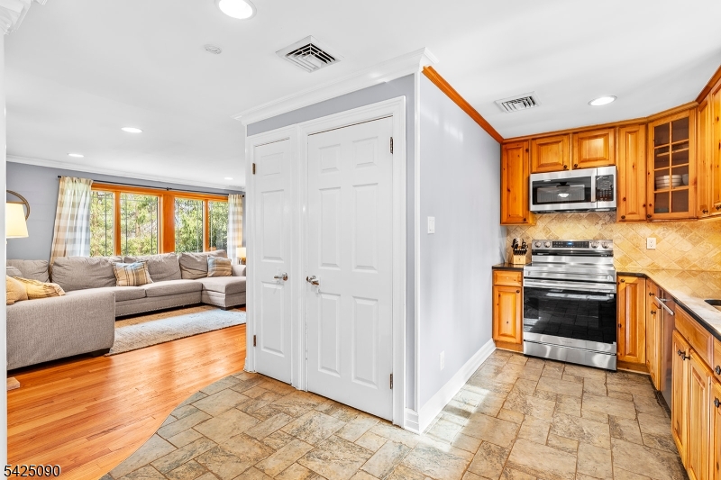 21 Turkey Hill Road Montville, NJ 07005 - Photo 12 of 32 a living room with stainless steel appliances furniture a flat screen tv and a window