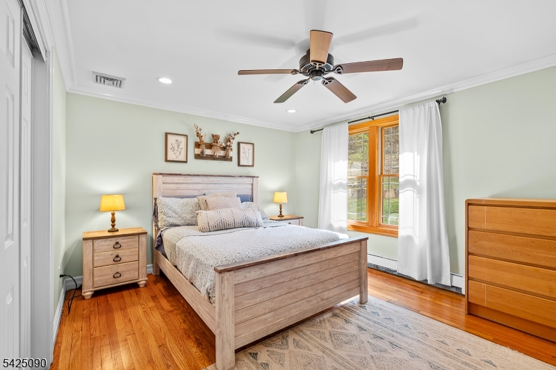 21 Turkey Hill Road Montville, NJ 07005 - Photo 13 of 32 a bedroom with a large bed and a chandelier