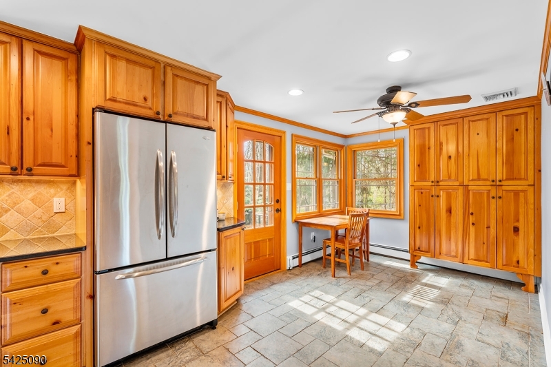 21 Turkey Hill Road Montville, NJ 07005 - Photo 10 of 32 a kitchen with stainless steel appliances a refrigerator and furniture