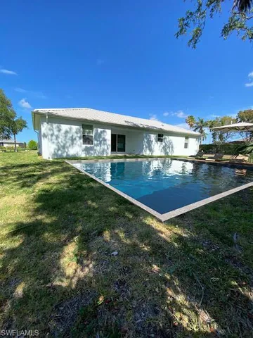 wooden floor in a hall with a chandelier