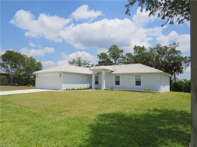 a view of a big yard with an ocean view