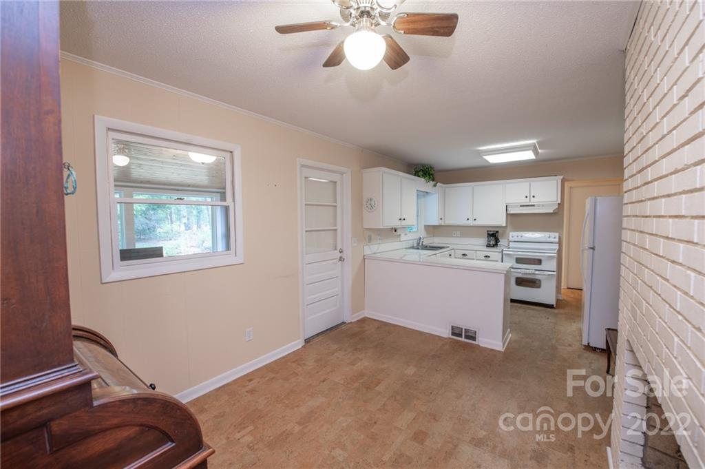 3255 Lake Shore Road South Denver, NC 28037 - Photo 21 of 32 a kitchen with a cabinets and chandelier