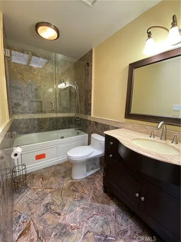 a kitchen with stainless steel appliances granite countertop a stove top oven a sink a dining table and chairs