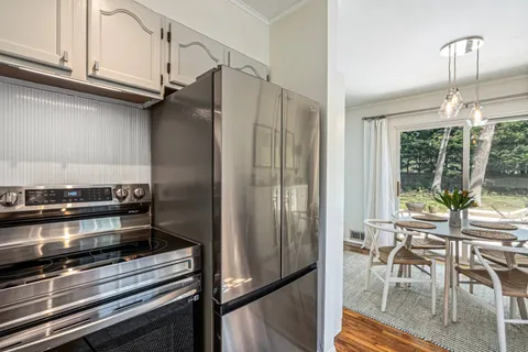 a kitchen with appliances and a table