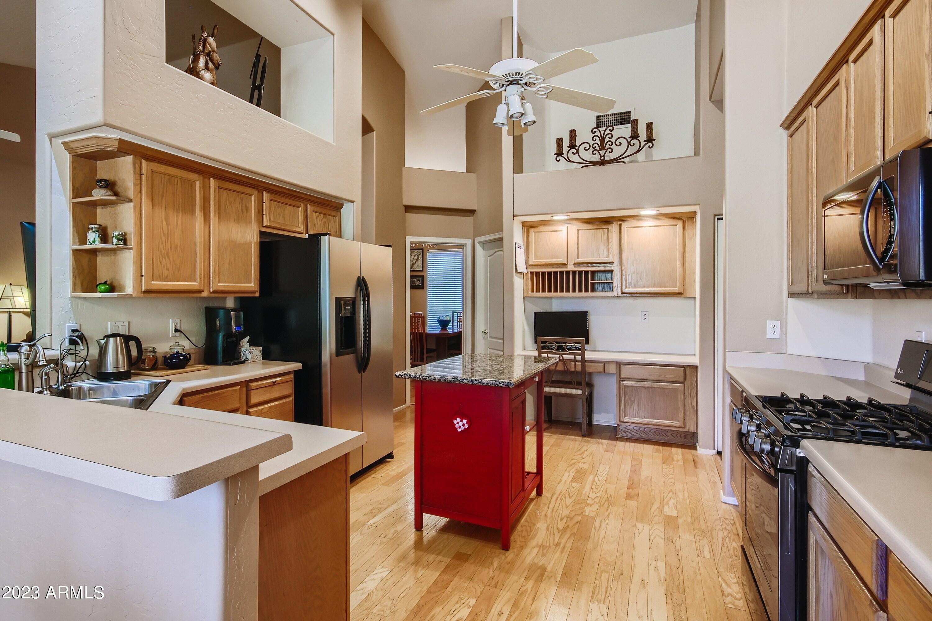 3060 North Ridgecrest, Unit 175 Mesa, AZ 85207 - Photo 10 of 28 a kitchen with stainless steel appliances granite countertop a refrigerator stove and sink
