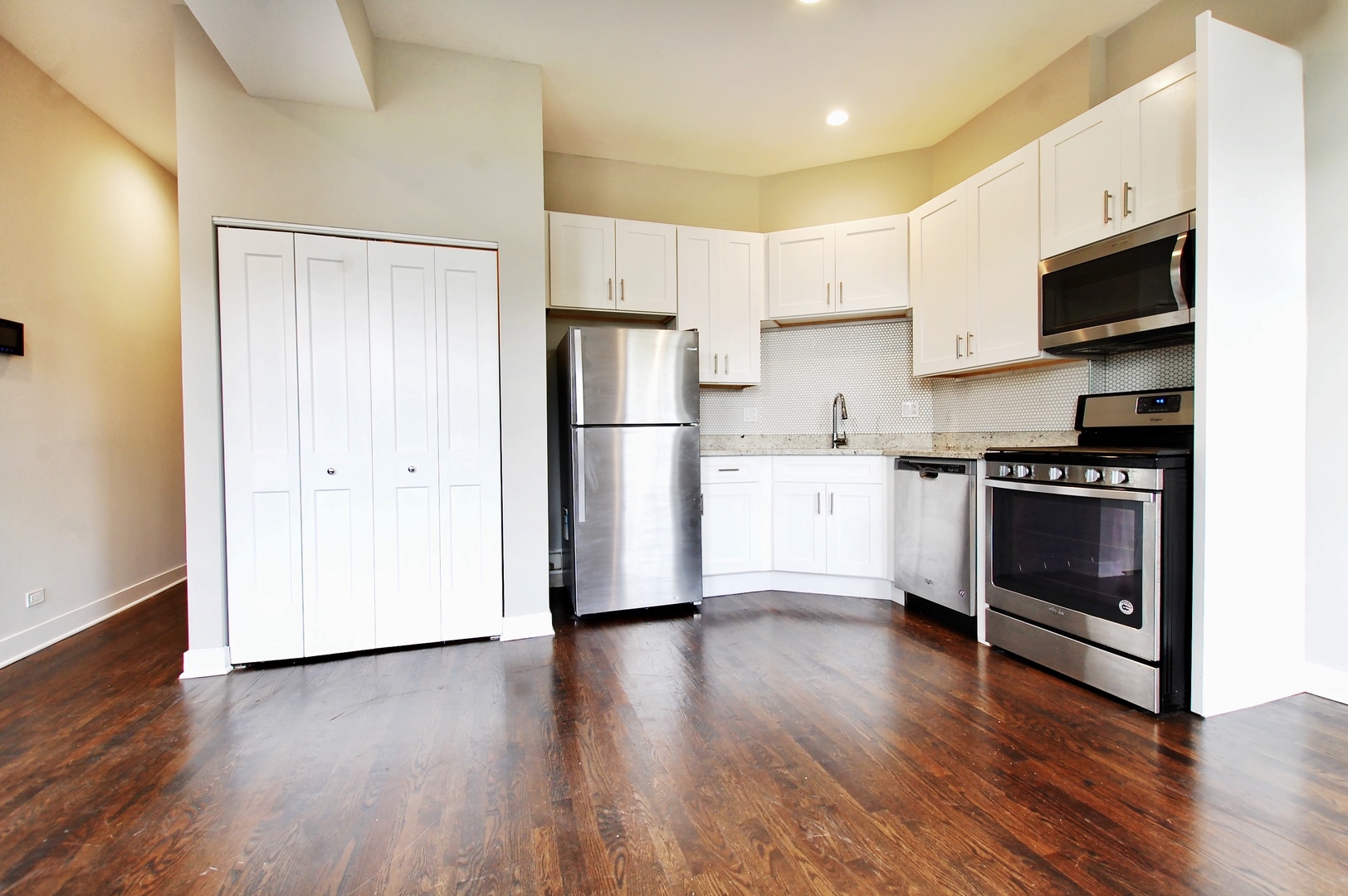 1854 West 18th Street, Unit 2F Chicago, IL 60608 - Photo 3 of 5 a kitchen with wooden floors and appliances