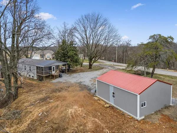 a view of a house with a yard and sitting area