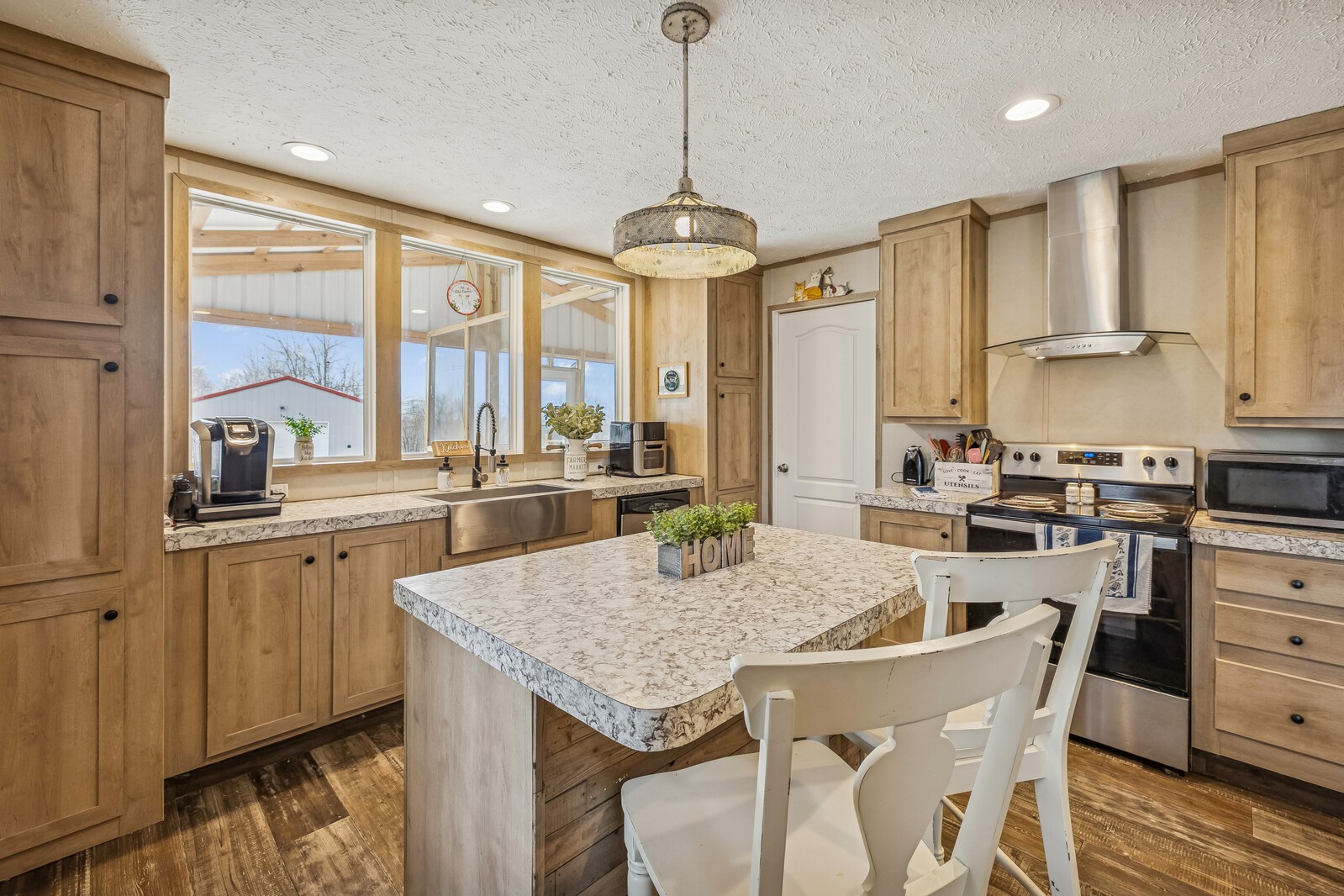 470 James Whitefield Road Bethpage, TN 37022 - Photo 7 of 22 a kitchen with granite countertop a stove a sink a dining table and chairs