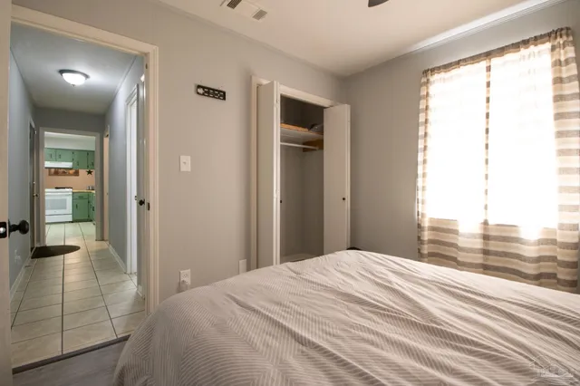 a bedroom with furniture and a window