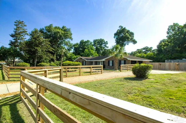 a view of a house with pool and sitting area