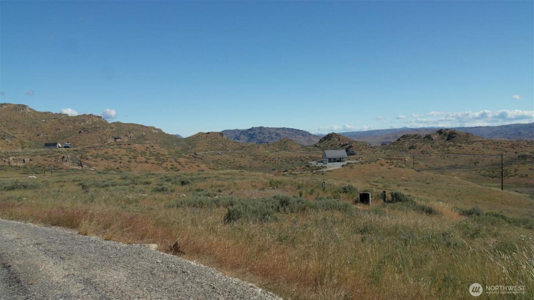 446 Plata Road Brewster, WA 98812 - Photo 4 of 32 a view of a dry field with mountains in the background