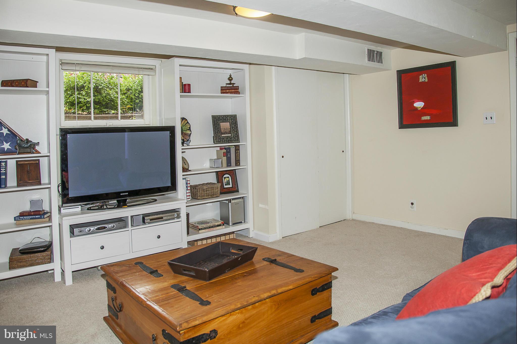 9508 Seminole Street Silver Spring, MD 20901 - Photo 22 of 28 a living room with furniture and a flat screen tv