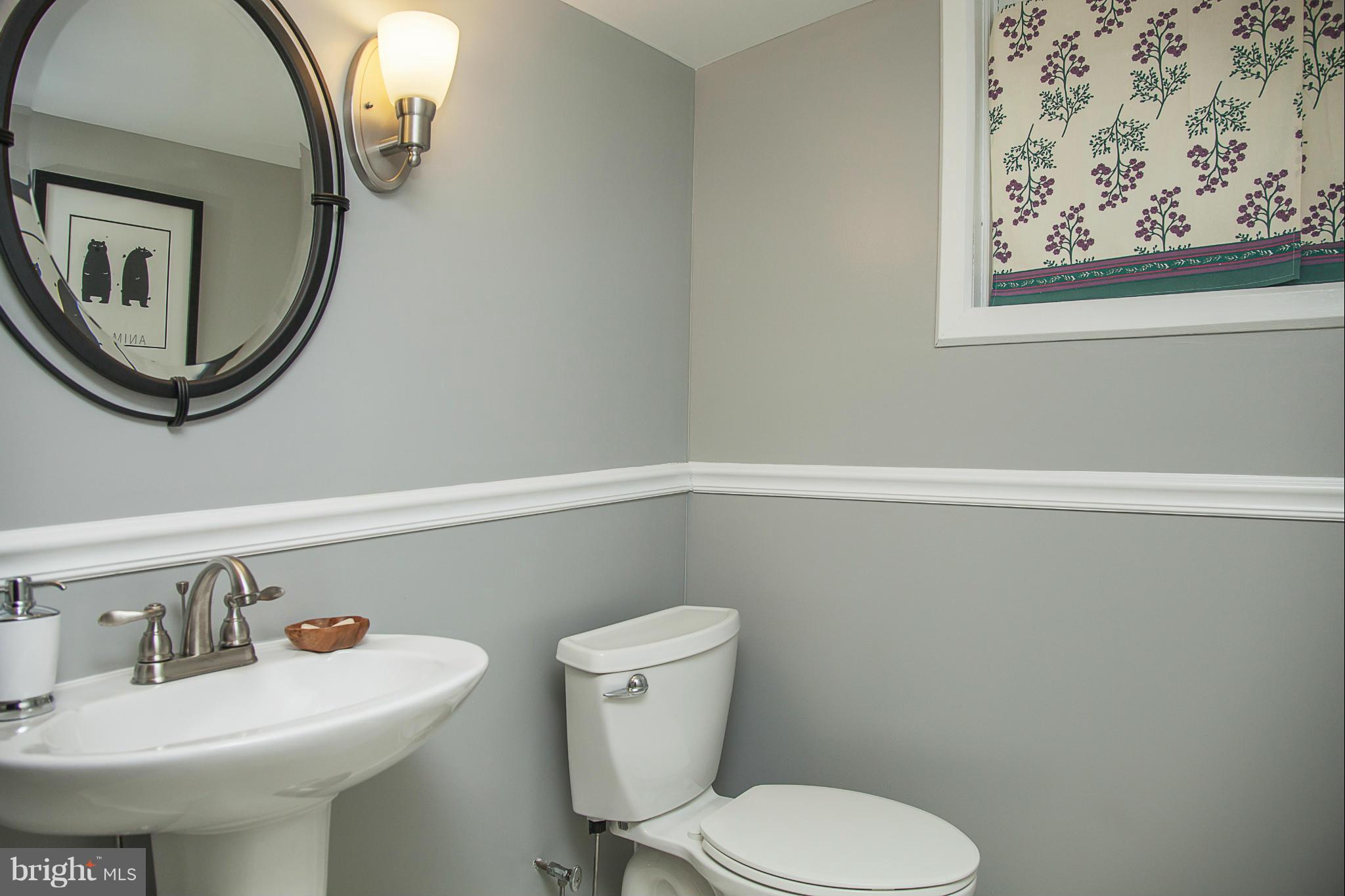 9508 Seminole Street Silver Spring, MD 20901 - Photo 26 of 28 a bathroom with a toilet a sink and mirror