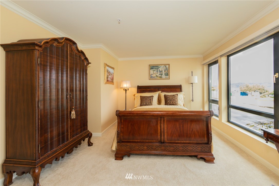 1331 Harbor Avenue Southwest, Unit 103 Seattle, WA 98116 - Photo 19 of 32 a bedroom with a bed and a large window