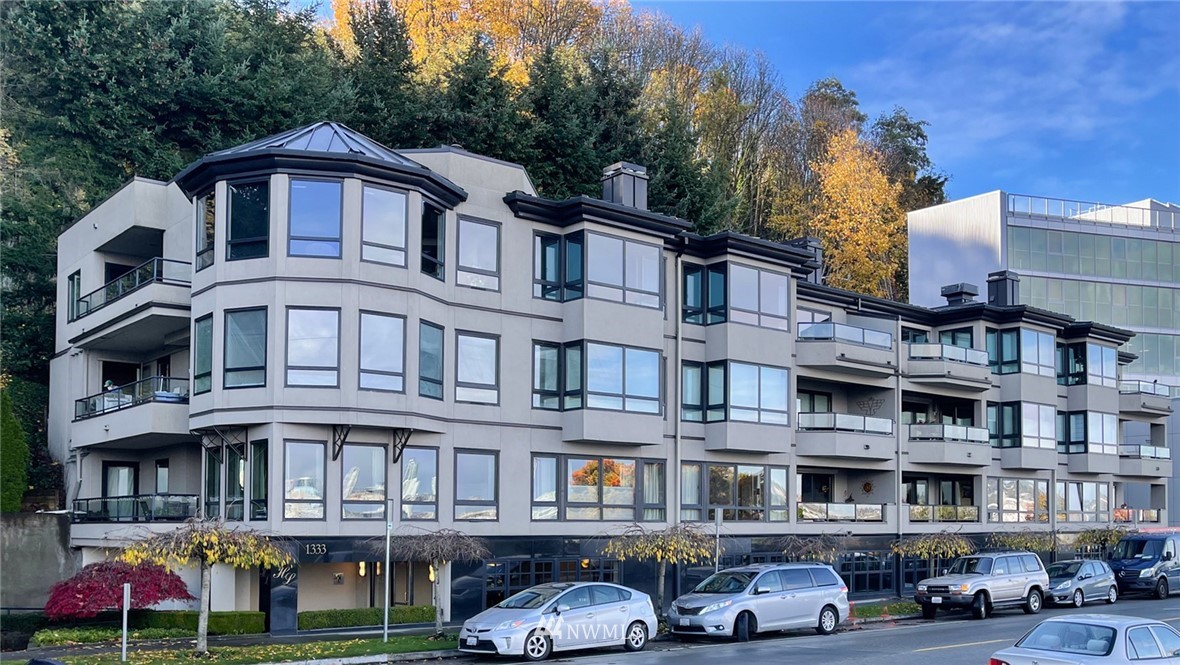 1331 Harbor Avenue Southwest, Unit 103 Seattle, WA 98116 - Photo 2 of 32 a front view of a residential apartment building with a yard