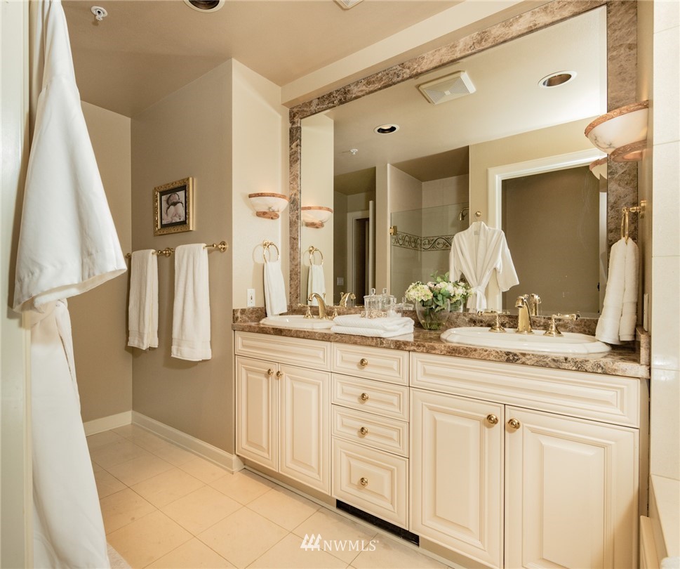 1331 Harbor Avenue Southwest, Unit 103 Seattle, WA 98116 - Photo 25 of 32 a bathroom with a double vanity sink and a mirror