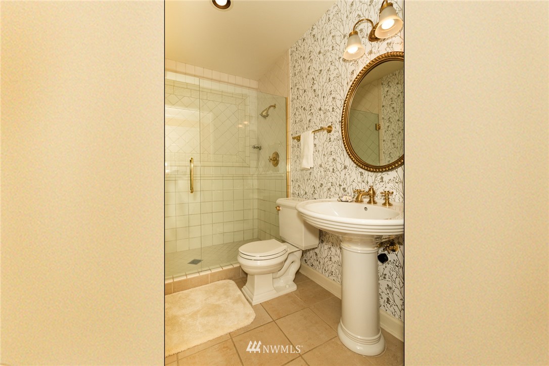 1331 Harbor Avenue Southwest, Unit 103 Seattle, WA 98116 - Photo 27 of 32 a bathroom with a toilet sink and mirror